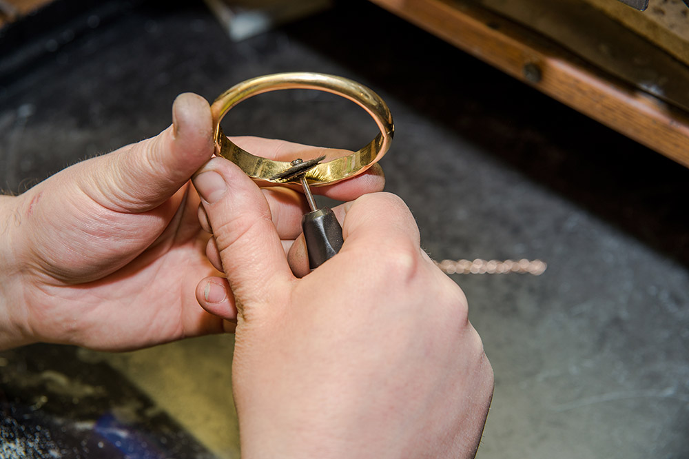 Jeweler edits a gold ring