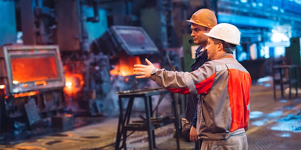 Workers at work in metal factory